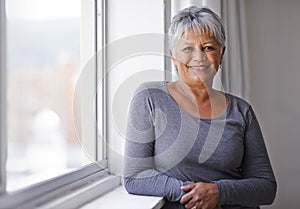 Portrait, smile and window with senior woman, happiness and sunshine with weekend break and casual outfit. Face