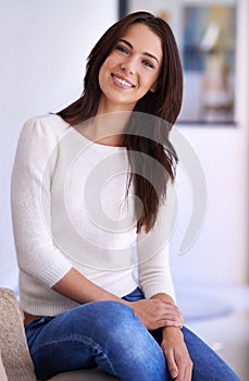 Portrait, smile and woman with confidence in home to relax on sofa on casual weekend in Canada. Comfort, pride and happy