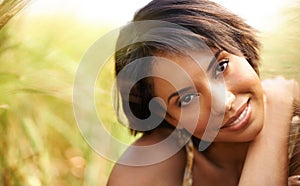 Portrait, smile and woman in field of grass in the countryside, summer outdoor for health or beauty. Face, happy person