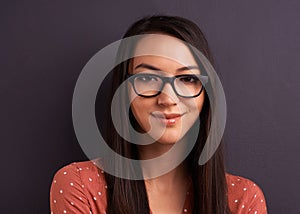Portrait, smile and woman with glasses, happiness and person on a grey studio background. Face, model and girl with