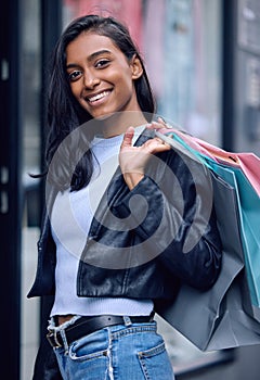 Portrait, smile and woman with shopping bag in city at mall for fashion, sales and discount at retail store. Happy girl