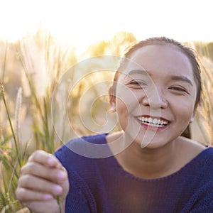 Portrait smile young girl at field gass