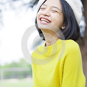 Portrait smile young girl wear yellow sweater on nature background