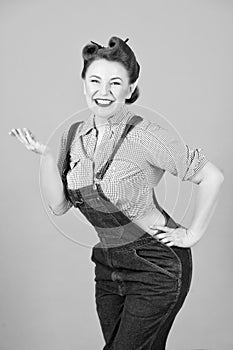 Portrait of smiled and cheerful pin-up girl standing with hand