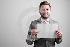 Portrait of smileing business man wearing business clothes holding white paper