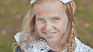Portrait of a smiling 13 year old blonde girl. Face close up.