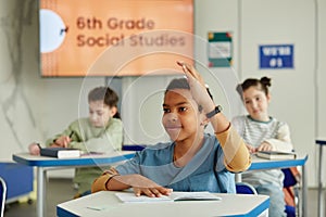 Excited Boy Raising Hand in Class