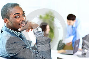 Portrait of smiling African American business man with executives