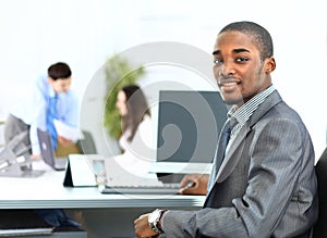 Portrait of smiling African American business man with executives