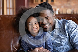 Portrait of smiling African American dad with daughter
