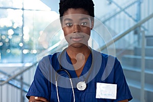 Portrait of smiling african american female doctor in hospital corridor