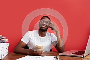 Portrait of smiling african man sitting at office desk