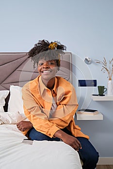 Portrait of smiling African woman in her cozy bedroom.