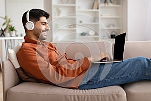 Portrait of smiling Arab man using pc at home