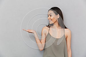 Portrait of a smiling asian woman holding copy space