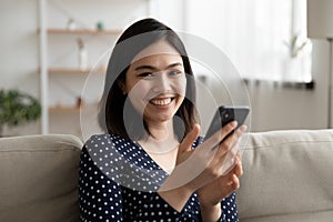 Portrait of smiling Asian woman using smartphone