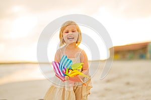 Portrait of smiling baby girl with windmill toy