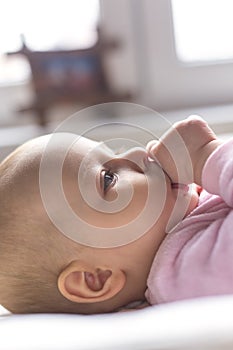 Portrait of a smiling baby laying on a changing table