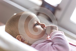 Portrait of a smiling baby laying on a changing table