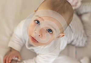 Portrait of a smiling baby laying on a changing table