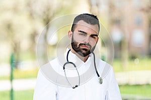 Portrait of a smiling bearded Male Caucasian Doctor in the Park, Global Pandemic