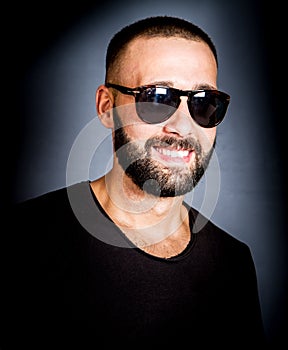 Portrait of smiling beared man with sunglasses