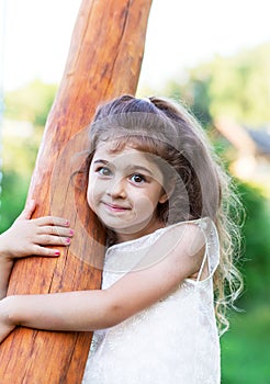 Portrait of smiling beautiful little girl at green of summer par