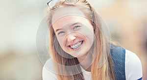 Portrait of a smiling beautiful teenage girl with dental braces