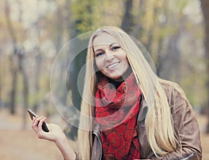 Portrait of a smiling beautiful woman texting sms