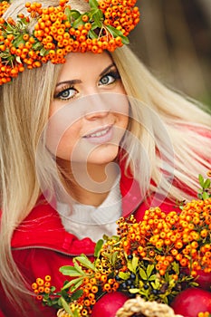 Portrait of smiling beautiful woman wreath of berries in autumn colors