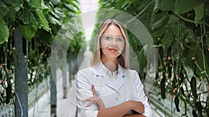 Portrait smiling beauty woman agronomist gardener scientist white coat posing at greenhouse