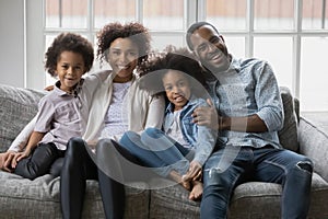 Portrait of smiling biracial family with kids relaxing