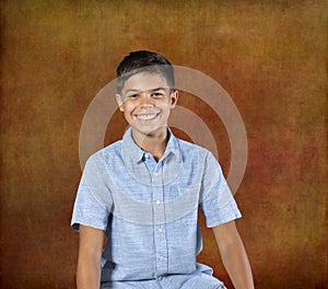 Portrait smiling biracial pre teen against textured background