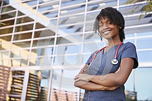 Portrait of smiling black female healthcare worker outdoors