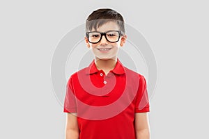 Portrait of smiling boy in glasses and red t-shirt