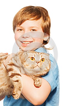 Portrait of smiling boy holding big cat