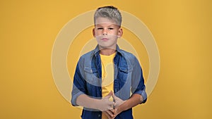 Portrait smiling boy kid video blogger talking gesticulation shooting content posing isolated