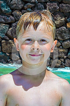 Portrait of a smiling boy with wet hair