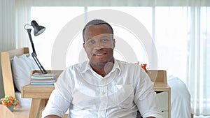 Portrait of smiling business black man, African American person working from home and talking to his colleagues in webcam group photo