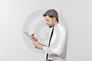 Portrait of a smiling business man with documents isolated on white background. Studio shot.