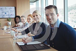 Portrait of smiling business people sitting at office