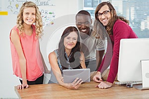 Portrait of smiling business team using digital tablet