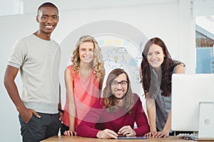 Portrait of smiling business team working at computer desk