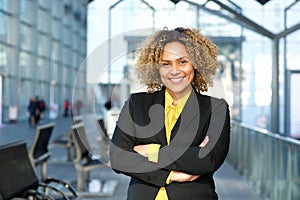 Portrait of smiling business woman with arms crossed