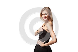 Portrait of smiling business woman standing with folded hands ov