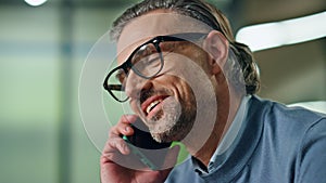 Portrait smiling businessman calling smartphone in office. Director mobile call