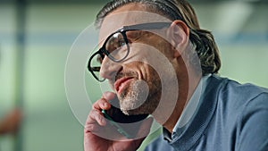 Portrait smiling businessman calling smartphone in office. Director mobile call