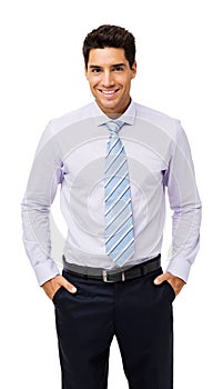 Portrait Of Smiling Businessman With Hands In Pockets