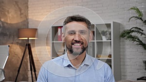 Portrait smiling businessman looking camera standing at home office