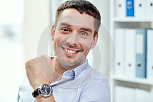 Portrait of smiling businessman in office